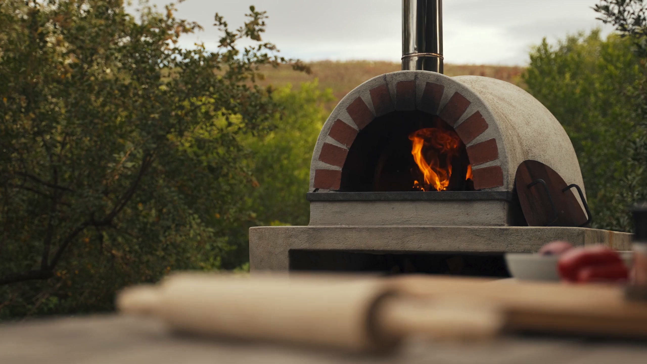 A wood-fired brick oven burning outdoors in the Snohomish countryside