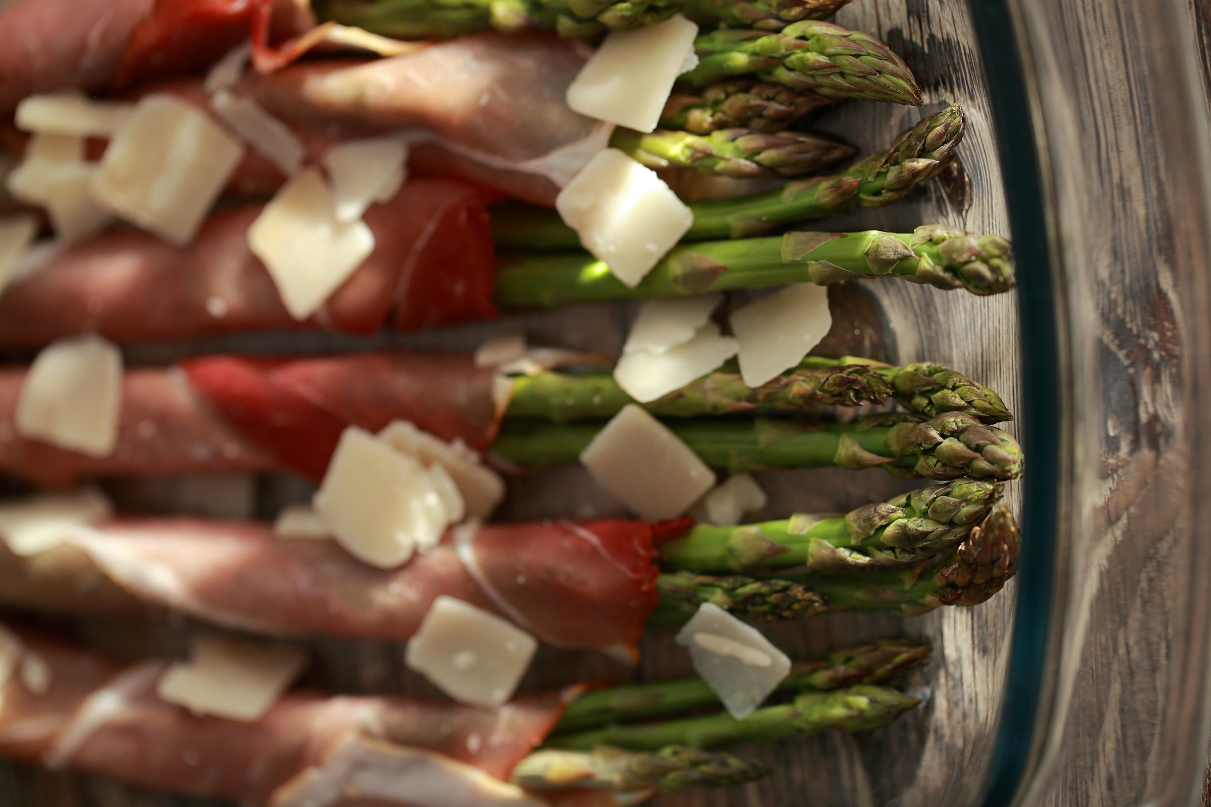 Asparagus spears wrapped in prosciutto with shaved parmesan